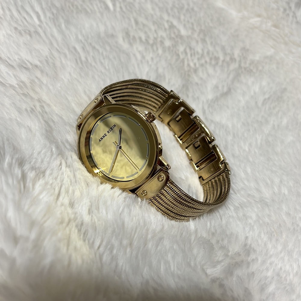 Women’s Anne Klein gold tone watch with stainless steel steel back